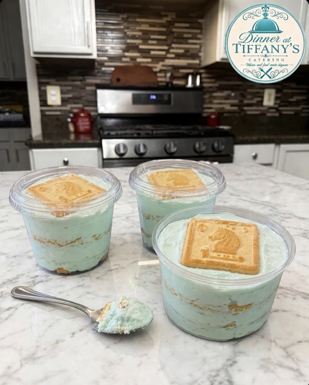 Tiffany's signature banana pudding cups with Chessmen cookies on white marble